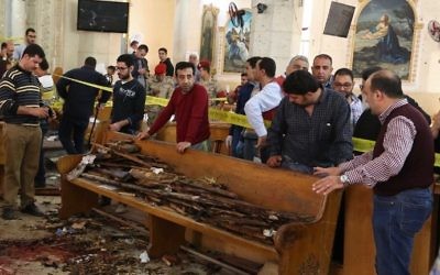 A general view shows forensics collecting evidence at the site of a bomb blast which struck worshipers gathering to celebrate Palm Sunday at the Mar Girgis Coptic Church in the Nile Delta City of Tanta, Egypt on April 9, 2017. (AFP PHOTO / STRINGER)