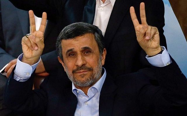 Former Iranian president Mahmoud Ahmadinejad (C) flashes the sign for victory at the interior ministry's election headquarters in Tehran on April 12, 2017. (AFP/Atta Kenare)