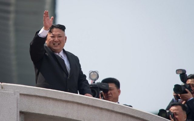North Korean leader Kim Jong-Un waves from a balcony of the Grand People's Study house following a military parade marking the 105th anniversary of the birth of late North Korean leader Kim Il-Sung, in Pyongyang on April 15, 2017. (AFP PHOTO / ED JONES)