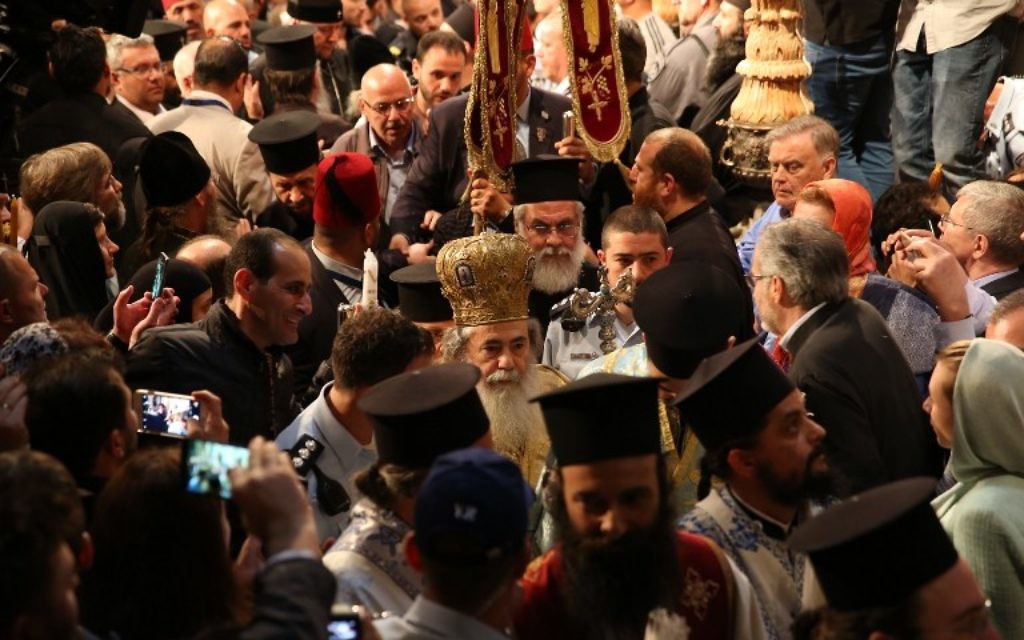 Greek Orthodox Patriarch of Jerusalem Theophilos III leads the Orthodox Easter ceremony of the 'Holy Fire' as thousands gather in the Church of the Holy Sepulchre in Jerusalem's Old City on April 15, 2017. (AFP/Gali Tibbon)