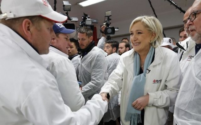 French presidential election candidate for the far-right Front National (FN) party, Marine Le Pen (2R) shakes hands with an employee as she visits the meat pavilion at the Rungis international food market, near Paris, on April 25, 2017. (Charles Platiau/AFP)