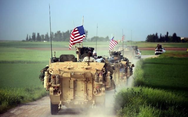 US forces, accompanied by Kurdish People's Protection Units (YPG) fighters, drive their armored vehicles near the northern Syrian village of Darbasiya on April 28, 2017. (AFP/Delil Souleiman)