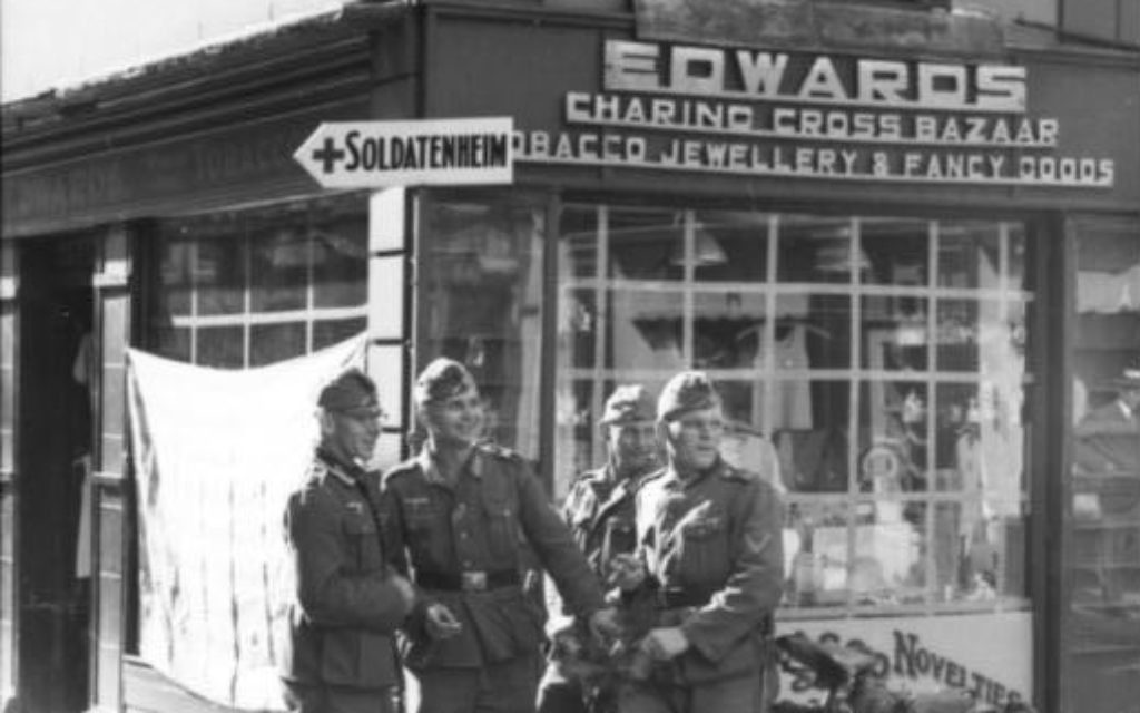 German soldiers standing at an intersection in Jersey during the WWII occupation of the Channel Islands. (Bundesarchiv Bild)