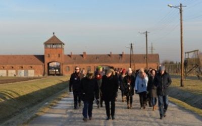 Rabbi Aubrey Hirsch, Amud Aish Memorial Museum lecturer, and Dr. Henri Lustiger-Thaler, the museum's senior curator, with the docent group in Birkenau. (Courtesy)