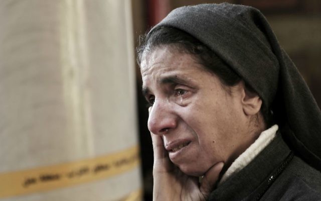 In this Dec. 11, 2016 file photo, an Egyptian Coptic nun weeps as she looks at damage inside the St. Mark Cathedral in central Cairo, following a bombing. (AP Photo/Nariman El-Mofty, File)