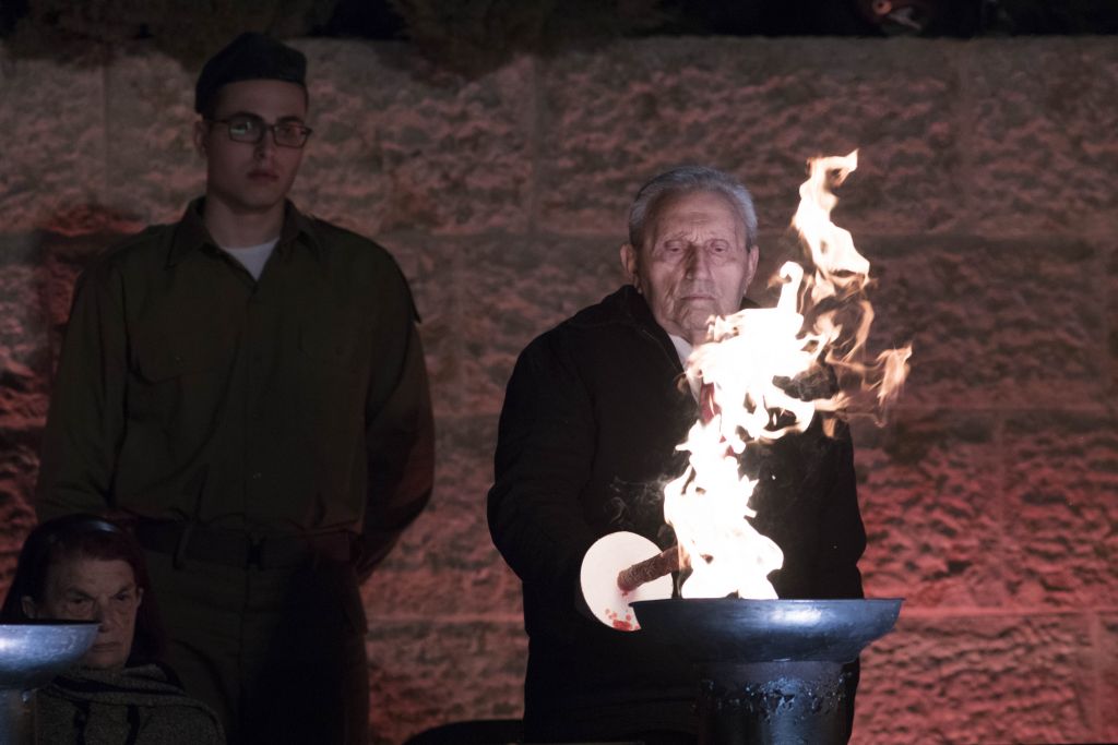 Holocaust survivors light six torches representing the six million victims of the Nazi genocide during the opening ceremony at the Yad Vashem Holocaust Memorial Museum in Jerusalem, as Israel marks the annual Holocaust Remembrance Day. April 23, 2017. (Yonatan Sindel/Flash90) 