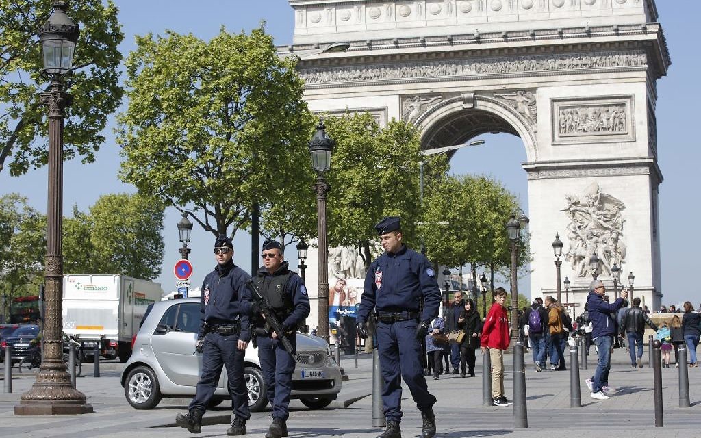 Illustrative: French police patrol the Champs Elysees boulevard, with the Arc de Triomphe in the background, in Paris, Friday, April 21, 2017. (AP Photo/Christophe Ena)