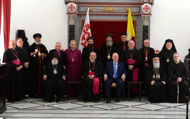 President Reuven Rivlin (seated center) visits the Latin Patriarchate in Jerusalem’s Old City in honor of Easter,
 April 19, 2017. (Mark Neiman/GPO)