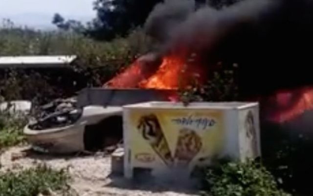 A screen shot from a video of dogs being burned alive in an abandoned car near the Israeli-Arab city of Umm al-Fahm. (Screenshot: Facebook)