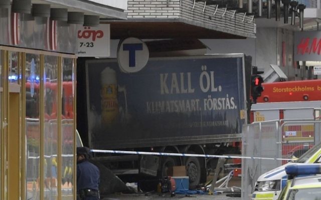 The rear of a truck, left, protrudes after it crashed into a department store injuring several people in central Stockholm, Sweden, Friday April 7, 2017. (Anders Wiklund , TT News Agency via AP) 