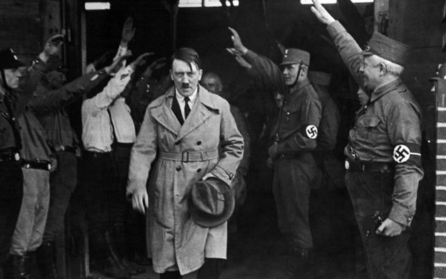 In this Dec. 5, 1931 file photo, Adolf Hitler, leader of the National Socialists, is saluted as he leaves the party's Munich headquarters.  (AP, File)
