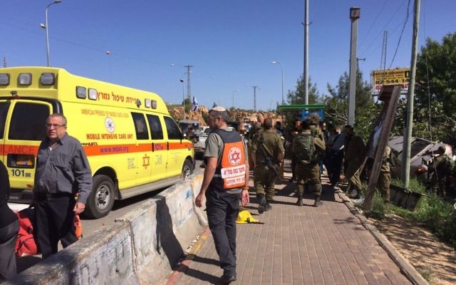 Medics and soldiers respond to a suspected car-ramming attack outside the Ofra settlement in the central West Bank on April 6, 2017. (Magen David Adom)
