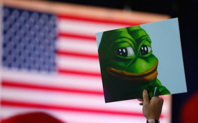 Illustrative: A Donald Trump supporter holds a poster of Pepe the Frog, a symbol of the alt-right movement, at a campaign event in Bedford, New Hampshire, on September 29, 2016. (Jessica Rinaldi/The Boston Globe via Getty Images/JTA)