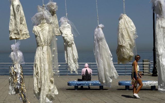 Lebanese activists use an installation of wedding dresses by Lebanese artist Mireille Honein at Beirut's Corniche to ramp up their campaign to press parliament to scrap Article 522 of Lebanon's penal code which allows rapists to escape punishement (AFP/Patrick Baz)