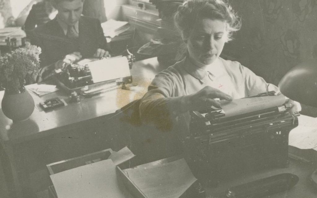 Justus Rosenberg, back, on a typewriter during WWII. (Courtesy)