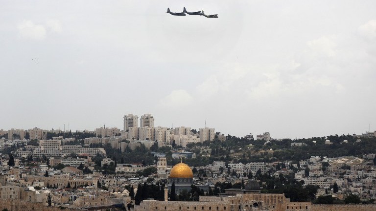 Israeli C-130 transport planes flt over Jerusalem during celebrations marking Israel's 69th Independence Day on May 2, 2017. (AFP Photo/Thomas Coex)