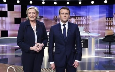 French presidential election candidates Marine Le Pen (L) and Emmanuel Macron pose prior to the start of a televised debate on May 3, 2017, as part of the second round election campaign. (AFP Photo/Pool/Eric Feferberg)