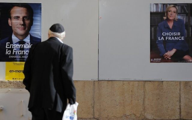 A Jewish man looks at election posters outside the French consulate in Jerusalem, on May 7, 2017 during the second round of the French presidential vote. (AFP Photo/Thomas Coex)