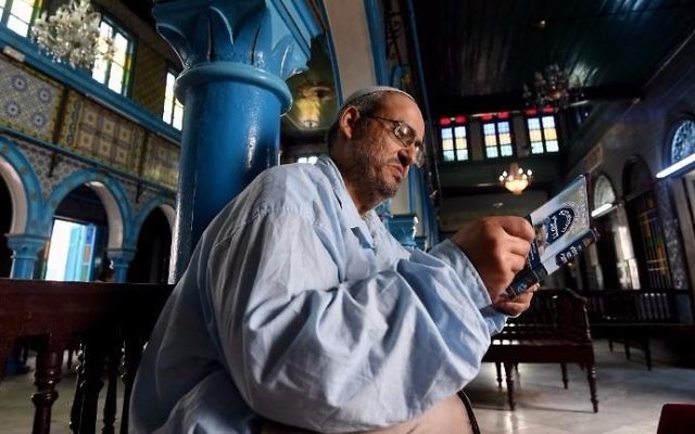 Tunisian Rabbi Daoud reads from a prayer book at the Ghriba Synagogue on the Tunisian resort island of Djerba on May 14, 2017, during the second day of the annual Jewish pilgrimage to the synagogue thought to be Africa's oldest. (FETHI BELAID / AFP)