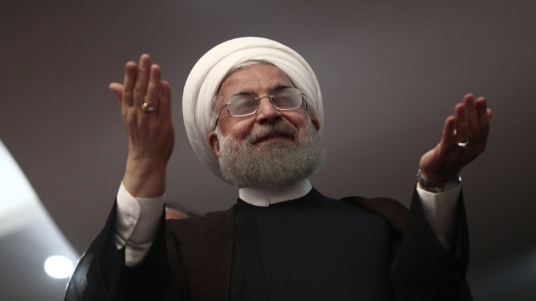 Iranian President and candidate in the upcoming presidential elections Hassan Rouhani gestures during a campaign rally in the northwestern city of Ardabil on May 17, 2017. (AFP Photo/Behrouz Mehri)
