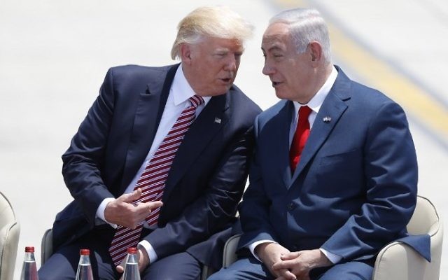 Prime Minister Benjamin Netanyahu (R) and US President Donald Trump speak upon the latter's arrival at Ben Gurion International Airport on May 22, 2017. (AFP Photo/Jack Guez)