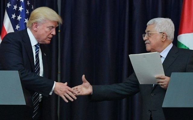 US President Donald Trump, left, and Palestinian leader Mahmoud Abbas shake hands during a joint press conference at the presidential palace in the West Bank city of Bethlehem on May 23, 2017. (AFP/MANDEL NGAN)