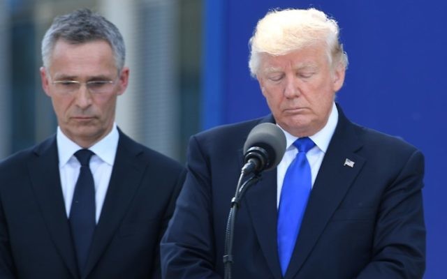 US President Donald Trump (R) stands next to NATO Secretary General Jens Stoltenberg (L) during the unveiling ceremony of the Berlin Wall monument, during the NATO (North Atlantic Treaty Organization) summit at the NATO headquarters, in Brussels, on May 25, 2017.  / AFP PHOTO / Emmanuel DUNAND