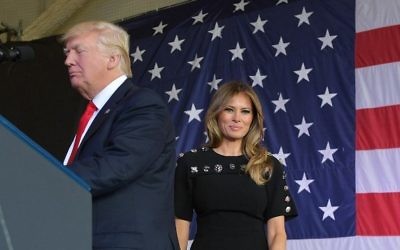US First Lady Melania Trump smiles on stage next to her husband US President Donald Trump during a meeting with US military personnel and families at Naval Air Station Sigonella after G7 summit of Heads of State and Government, on May 27, 2017 near Taormina in Sicily. (AFP PHOTO / MANDEL NGAN)