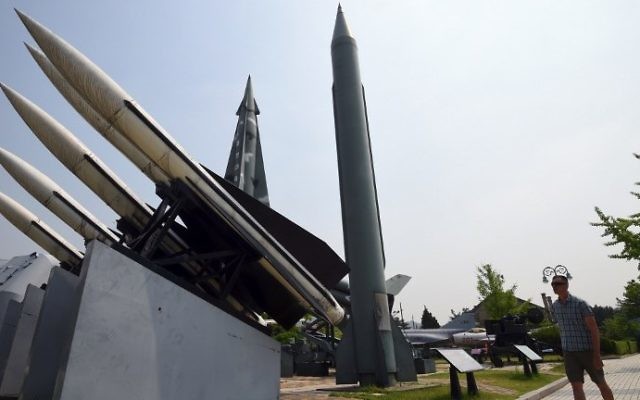 A man walks past replicas of a North Korean Scud-B missile (C) and South Korean Hawk surface-to-air missiles (L) at the Korean War Memorial in Seoul on May 29, 2017 (AFP PHOTO / JUNG Yeon-Je)