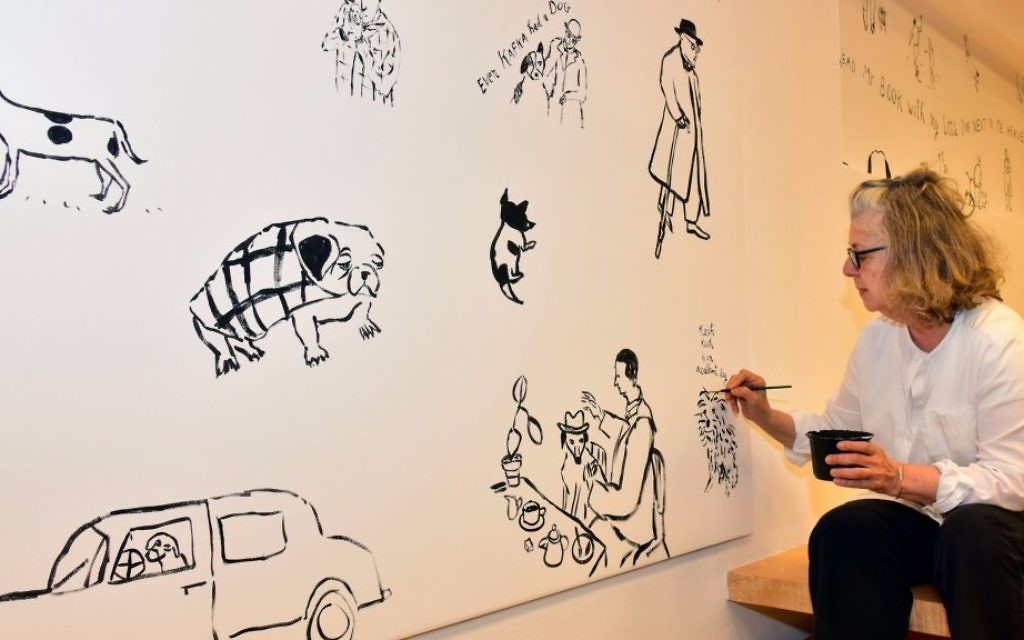 Illustrator Maira Kalman putting the finishing touches on her mural at the Israel Museum's Youth Wing, part of the 'Cats and Dogs' exhibit (Courtesy Benni Maor)
