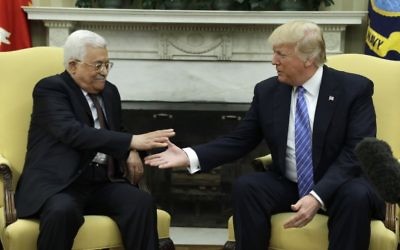 US President Donald Trump (right) reaches to shake hands with Palestinian leader Mahmoud Abbas, May 3, 2017, in the Oval Office of the White House in Washington. (AP Photo/Evan Vucci)