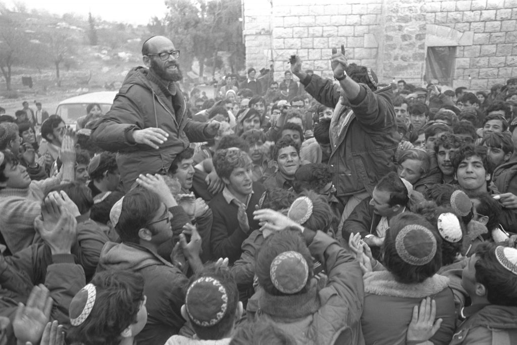 Rabbi Moshe Levinger (L), Gush Emunim leader Hanan Porat (R) and fellow activists, celebrate the government's 1975 agreement which allows all settlers to relocate to a military camp near the Arab village of Sebastia and additional locations in the Samaria region. (Moshe Milner)