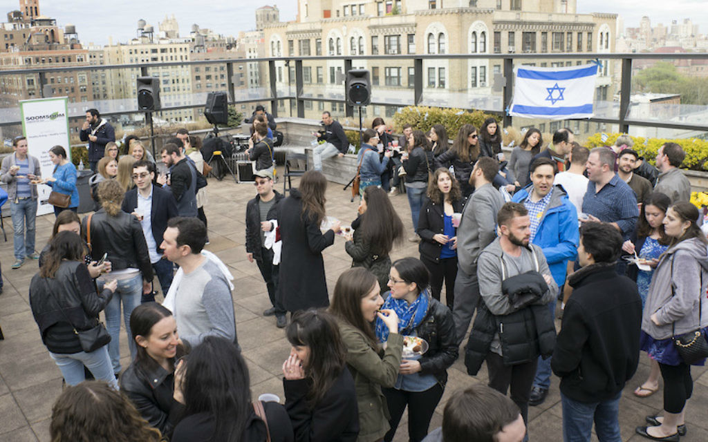 Participants in a past Shavuot program at JCC Manhattan gather on the JCC's roof. The JCC's annual event lasts all night and features an array of classes and workshops. (Courtesy of JCC Manhattan/via JTA)