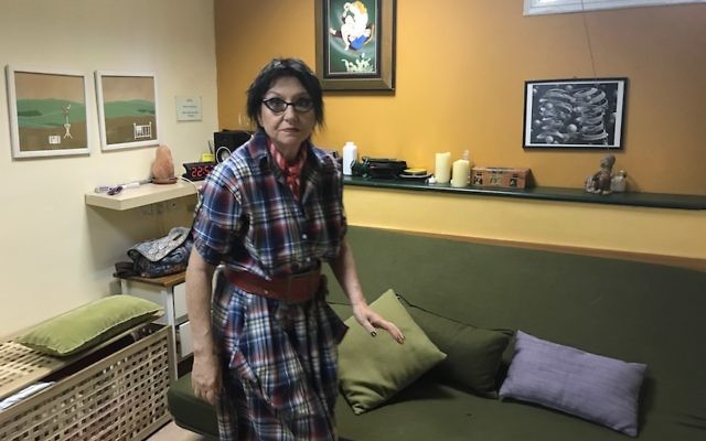 Office manager Ruta Cohn tidying up the green room at the Ronit Aloni Clinic in Tel Aviv, May 9, 2017. (Andrew Tobin via JTA)