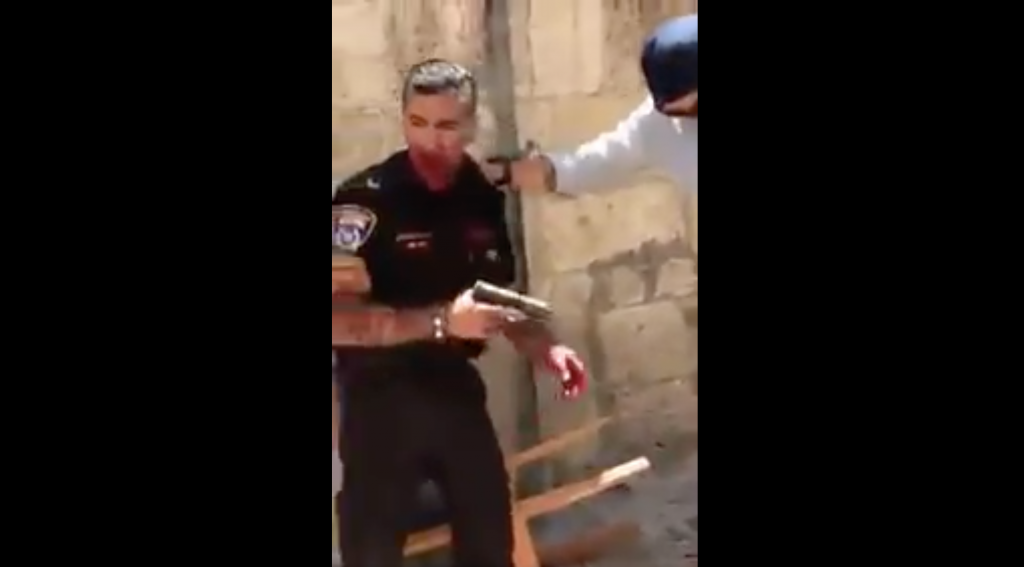 A still from footage showing a police officer after he was stabbed by an assailant on Saturday, May 13, 2017 in Jerusalem's Old City. Israel police said the attacker, a Jordanian man, was shot and died of his wounds. The policeman was hospitalized with moderate injuries. (screen capture: Quds News Network/Twitter) 