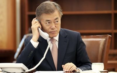 South Korean President Moon Jae-in talks on phone with Japanese Prime Minister Shinzo Abe at the presidential Blue House in Seoul, South Korea, May 11, 2017. (Yonhap via AP)