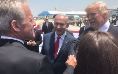 Arriving in Israel, US President Donald Trump shakes hands with former US ambassador to the US, Deputy minister Michael Oren MK, at Ben-Gurion Airport on May 21, 2017 (Courtesy)
