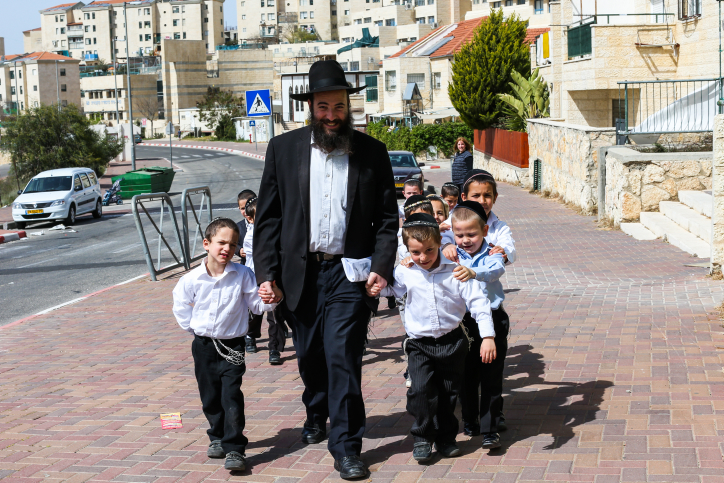 Illustrative image of an ultra orthodox teacher takes the kids from his class to a walk in the sun on March 12, 2013, in the West Bank settlement of Beitar Ilit. (Nati Shohat/Flash90)