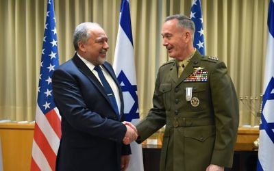Chairman of the US Joint Chiefs of Staff Joseph Dunford, right, shakes hands with Defense Minister Avigdor Liberman in the ministry's Tel Aviv headquarters on May 9, 2017. (Ariel Hermoni/Defense Ministry)