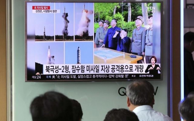 People watch a TV news program showing images of North Korean leader Kim Jong Un and the missile launch, published in the North Korea's Rodong Sinmun newspaper, at Seoul Railway station in Seoul, South Korea, Monday, May 22, 2017. (AP Photo/Lee Jin-man)