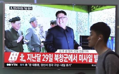 A man passes by a TV news program showing a file image of North Korean leader Kim Jong Un, at the Seoul Railway Station in Seoul, South Korea, Sunday, May 21, 2017. (AP Photo/Ahn Young-joon)