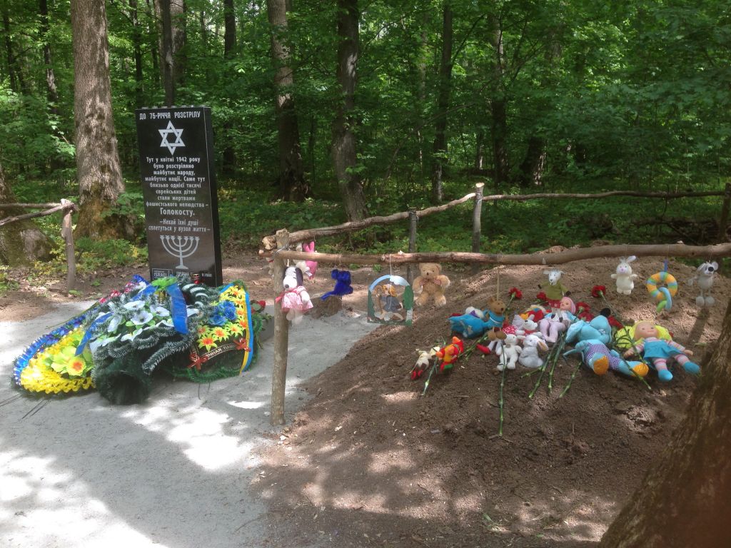 Memorial next to newly-covered over grave of Jewish kids shot by Nazis in 1942. The mass grave was decorated with children's toys for the ceremony on May 9, 2017. (Sue Surkes)