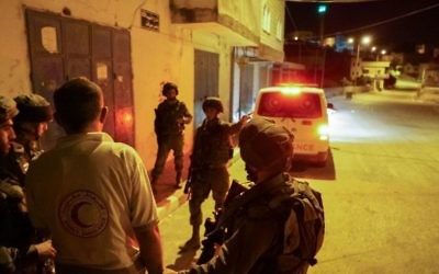 IDF arrests an ambulance driver, impounds his vehicle in the northern West Bank on May 19, 2017. The ambulance blocked the escape of an Israeli man who came under attack by a mob during a protest in the village of Hawara, outside Nablus. (IDF Spokesperson's Unit)