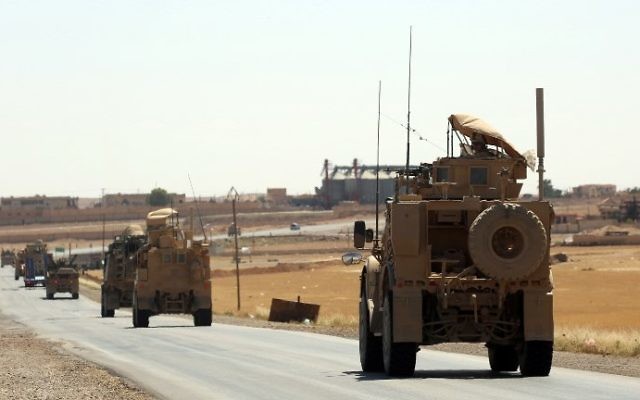 US-made armored vehicles are seen on a road near the northern Syrian village of Ain Issa on June 3, 2017. (AFP PHOTO / DELIL SOULEIMAN)