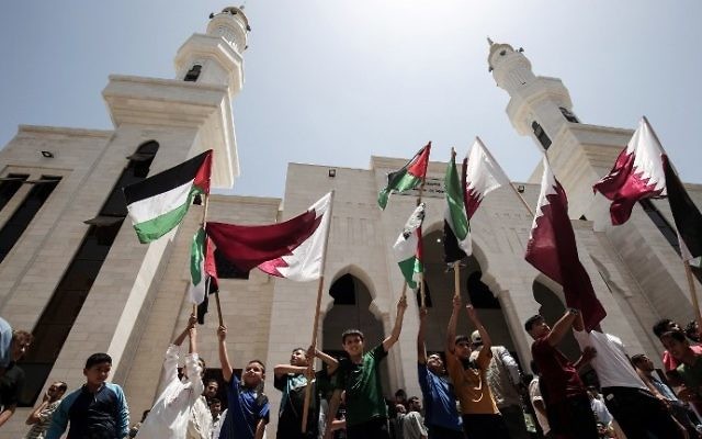Palestinians rally in support of Qatar at a Qatari-funded housing project in the southern Gaza city of Khan Younis on June 9, 2017. (AFP Photo/Said Khatib)