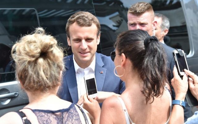 French President Emmanuel Macron (C) meets people as he leaves his home in Le Touquet, northern France, on June 11, 2017, during the first round of France's legislative elections. (Philippe Huguen/AFP)