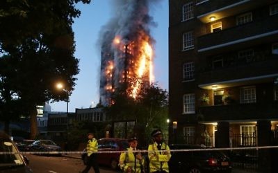 Police at a security cordon as a huge fire engulfs the Grenfell Tower in West London, June 14, 2017. (AFP Photo/Daniel Leal-Olivas)