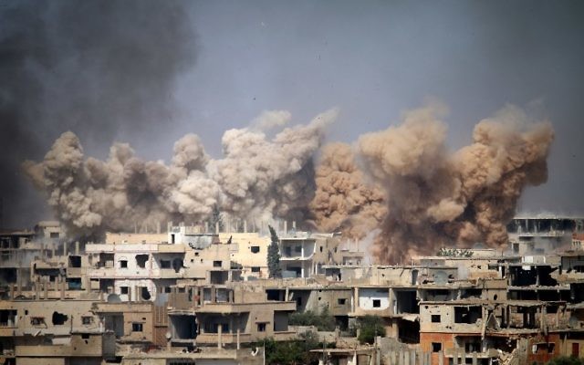 Smoke rises from buildings following a reported air strike on a rebel-held area in the southern Syrian city of Daraa, on June 14, 2017. (AFP/Mohamad Abazeed)