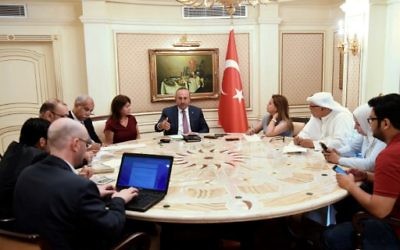Turkish Foreign Minister Mevlut Cavusoglu (C) attends a press conference in Kuwait City on June 15, 2017. (AFP Photo/Yasser Al-Zayyat)