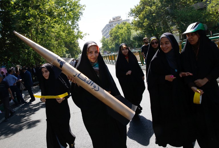 An Iranian girl holds a model of a missile during a rally marking al-Quds (Jerusalem) Day in Tehran on June 23, 2017. (AFP PHOTO / Stringer)